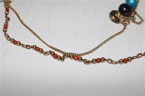 A 9ct gold necklace hung with four egg shaped charms and a 9ct gold and coral bead necklace.